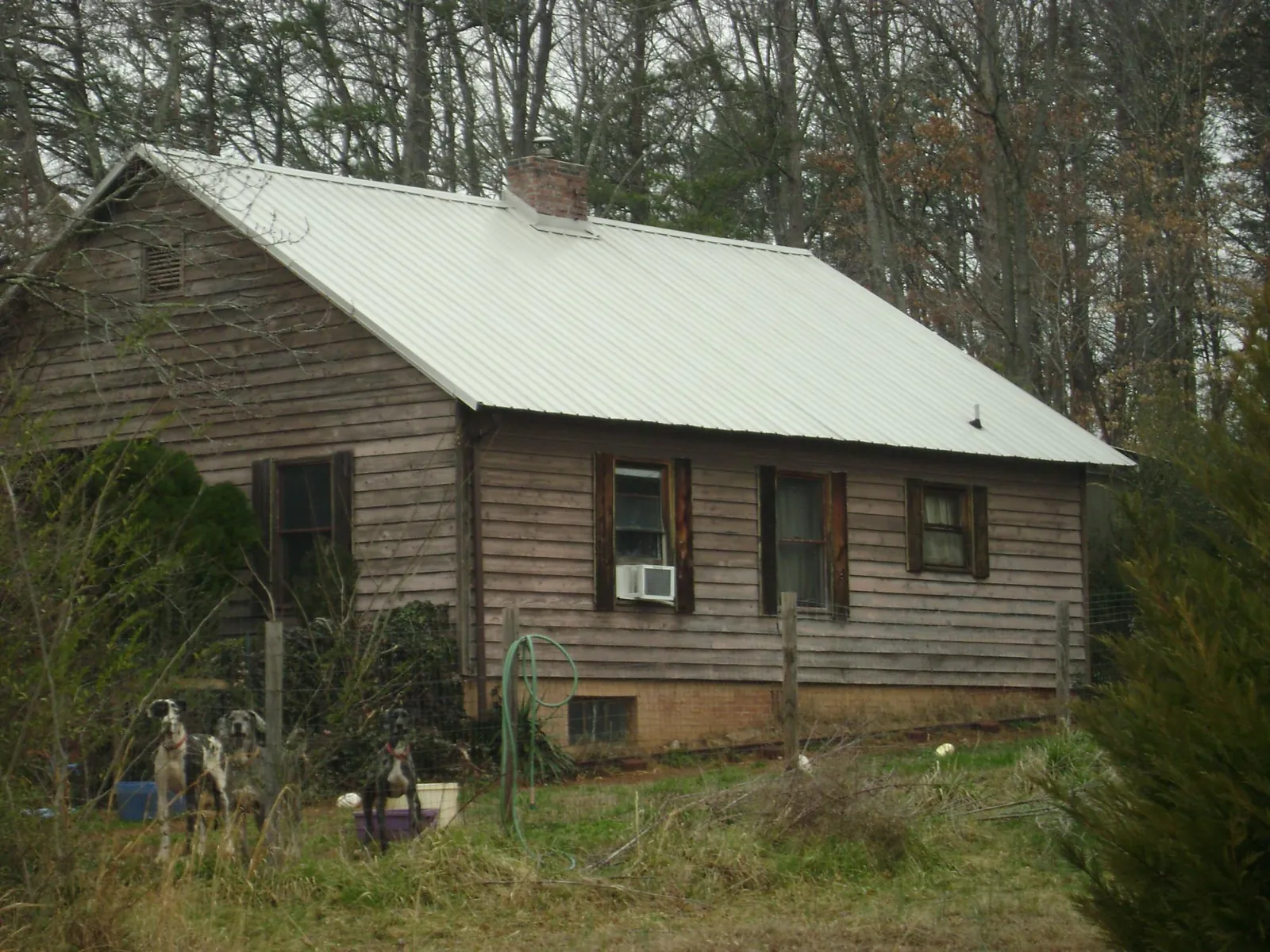 White metal roof on an old wood sided farmhouse, from a Metal Roof Installation job in Barksdale